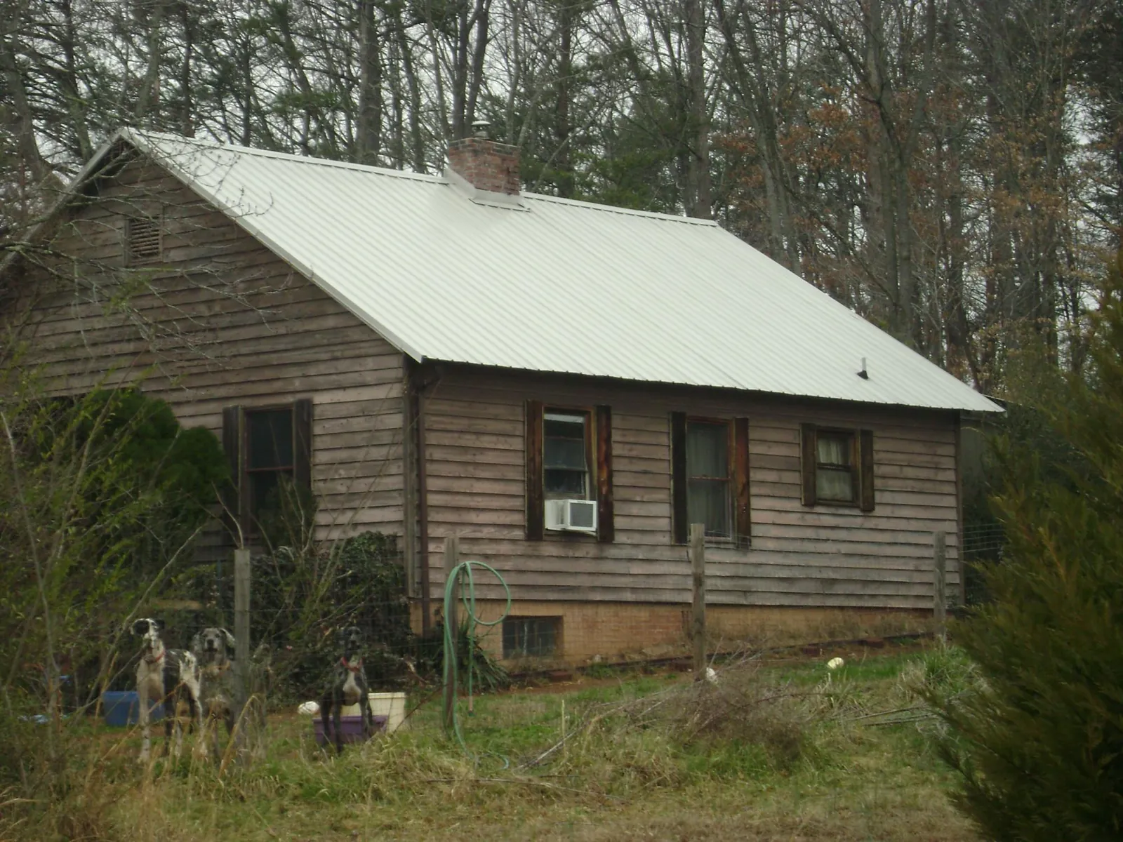 White metal roof on an old wood sided farmhouse, from a Metal Roof Installation job in Kahoka